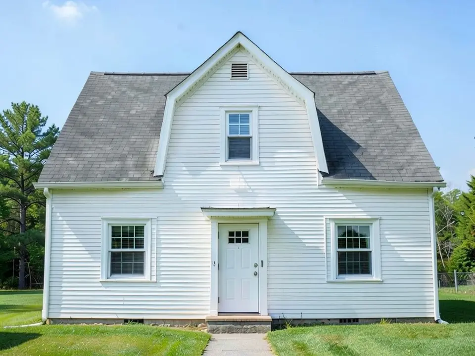 The same white house where the front gable now has a bell shape with two slopes on each side, in the barn-style gambrel form, with a vent and a small window