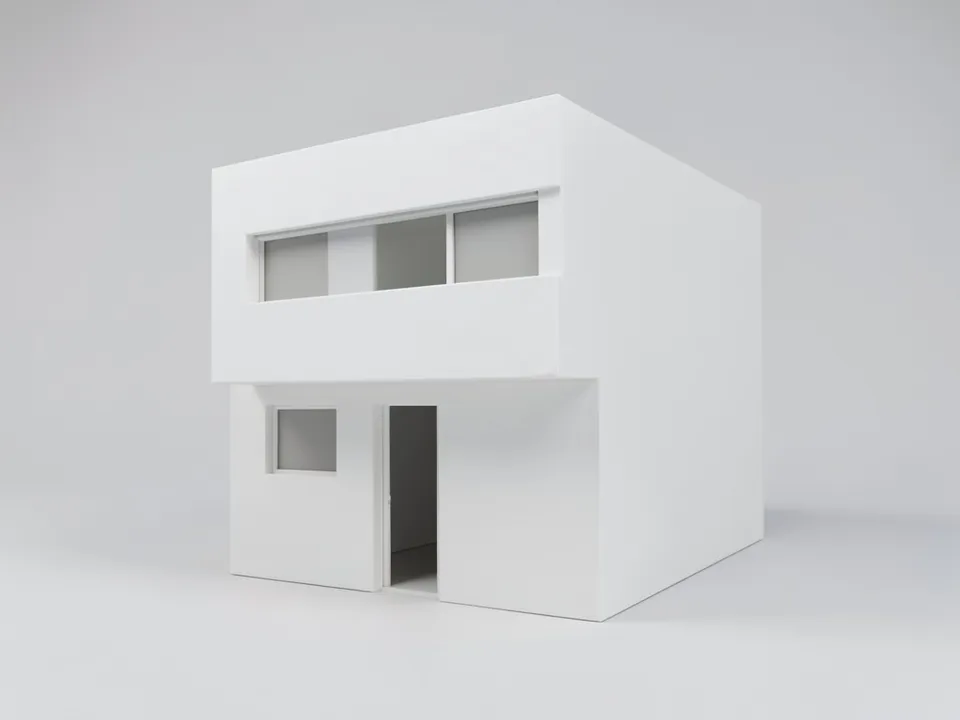 A plain white clay model of a box-shaped two-storey house with a flat roof, the upper floor cantilevered over the entrance, a long window band on the upper floor and a tall entrance opening, on a light grey ground
