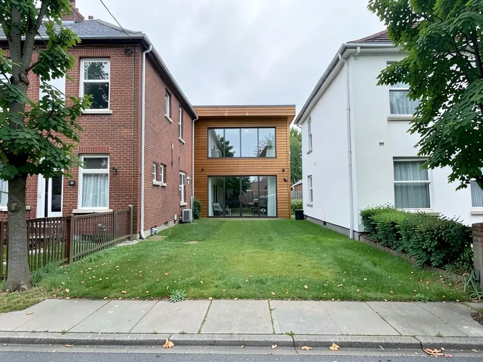 The same street view with a two-storey timber-clad house with a flat roof and large glass windows added on the plot, squeezed between the same brick and white neighbours, lawn and sidewalk unchanged in front